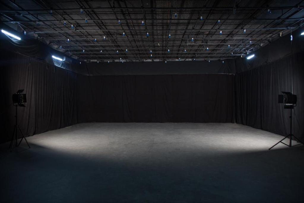 The main studio floor at The Victoria, with a lighting grid and black drapes